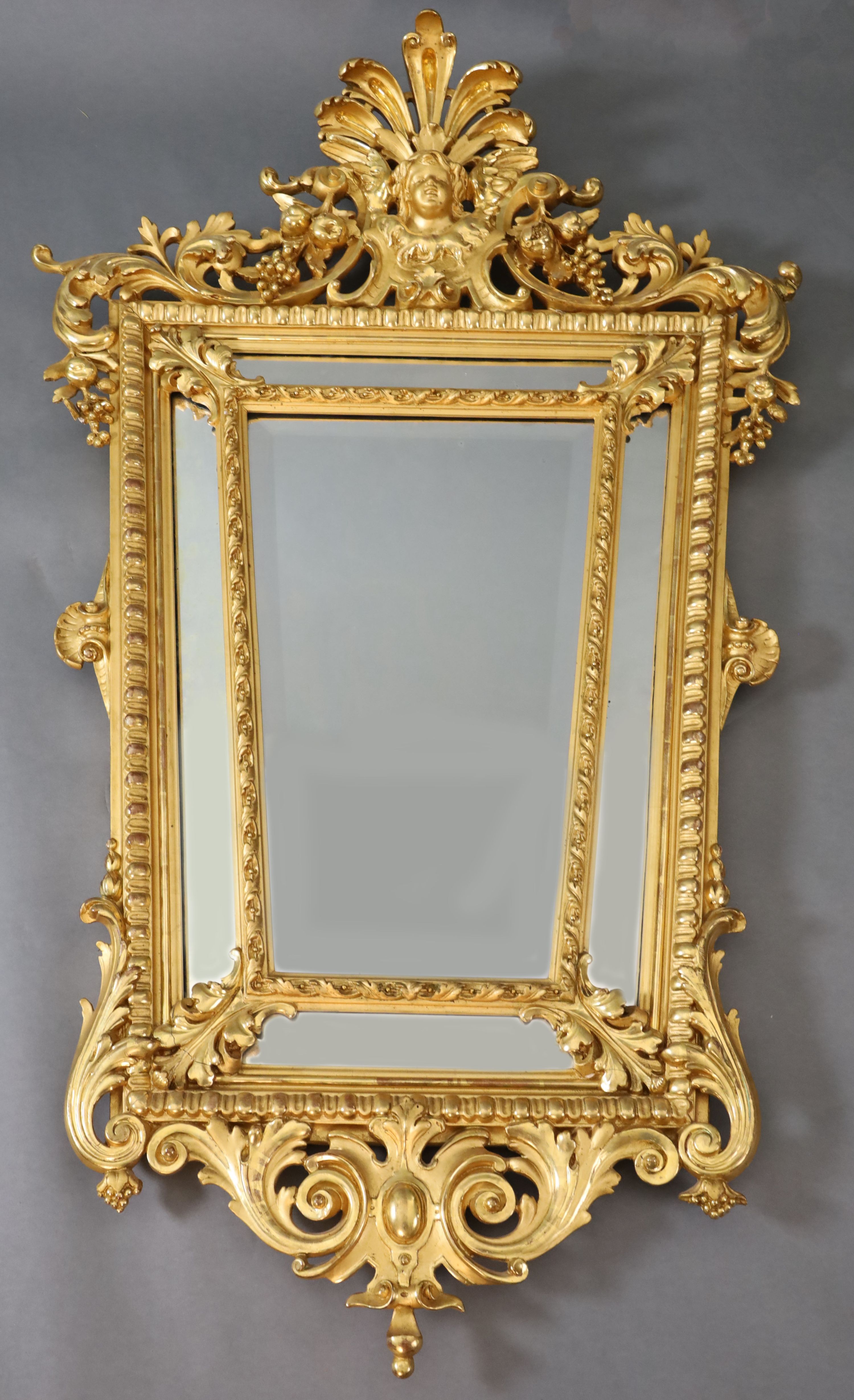 A Louis XIV style carved giltwood wall mirror, W.3ft 1in. H.5ft 1in.